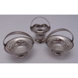 A pair of hallmarked silver bonbon dishes with swing handles, Birmingham 1912 and another with