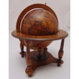 An Olde World Globe mounted in a mahogany stand with four supporting columns on peg feet, 38cm (h)