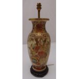 An oriental baluster form lamp base decorated with panels of warriors in full armour on carved