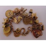 9ct gold charm bracelet with twenty four charms, approx total weight 46.7g