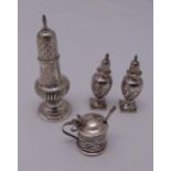 A quantity of hallmarked silver to include a Victorian sugar castor, a pair of pepperettes, a