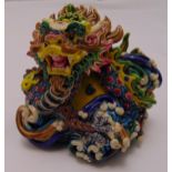 A Chinese polychromatic ceramic figurine of a stylised dragon,
