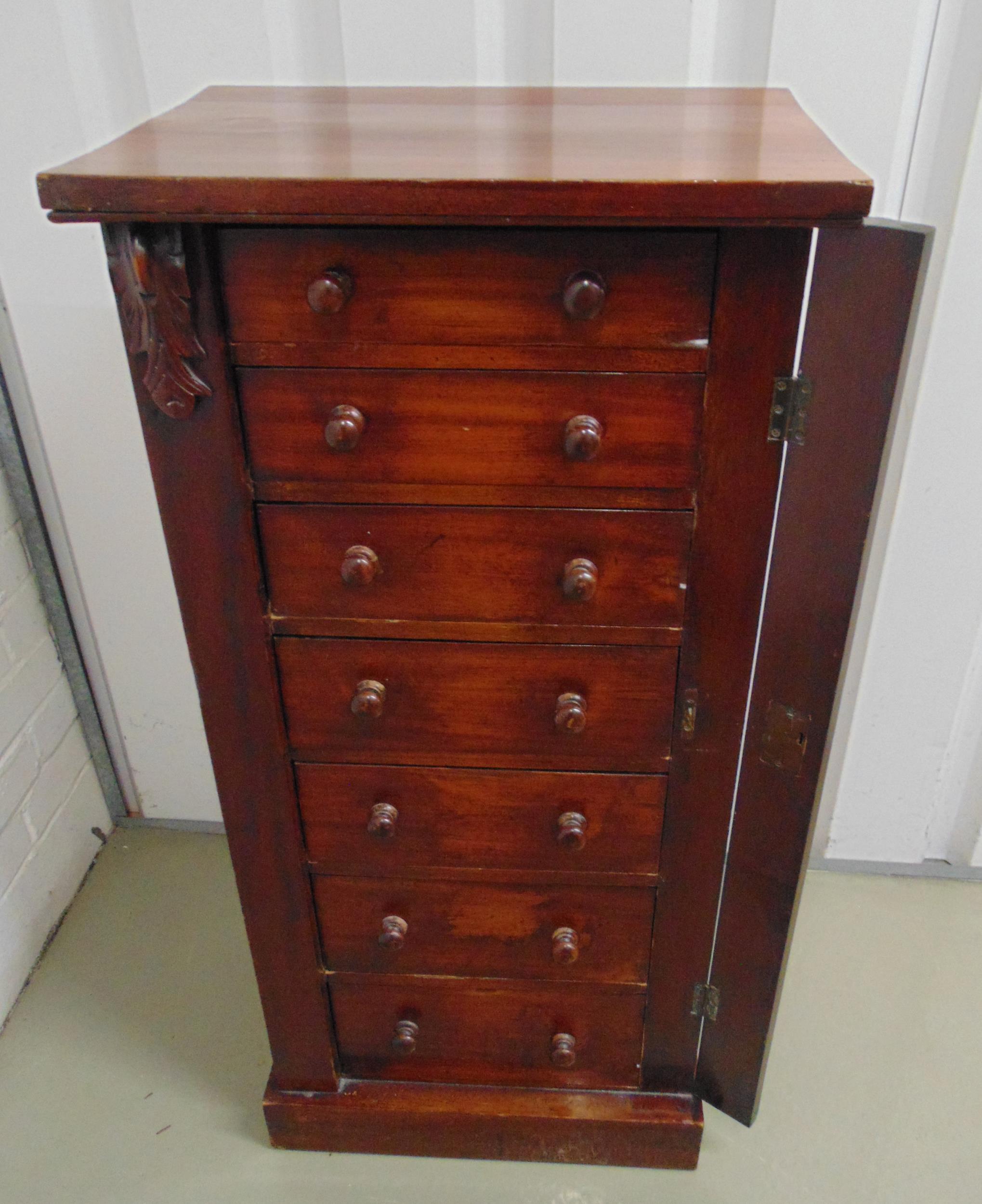 An early 19th century mahogany Wellington chest with seven drawers and turned wooden handles, by A