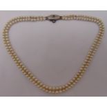 A double row of pearls with a white gold, diamond and sapphire clasp