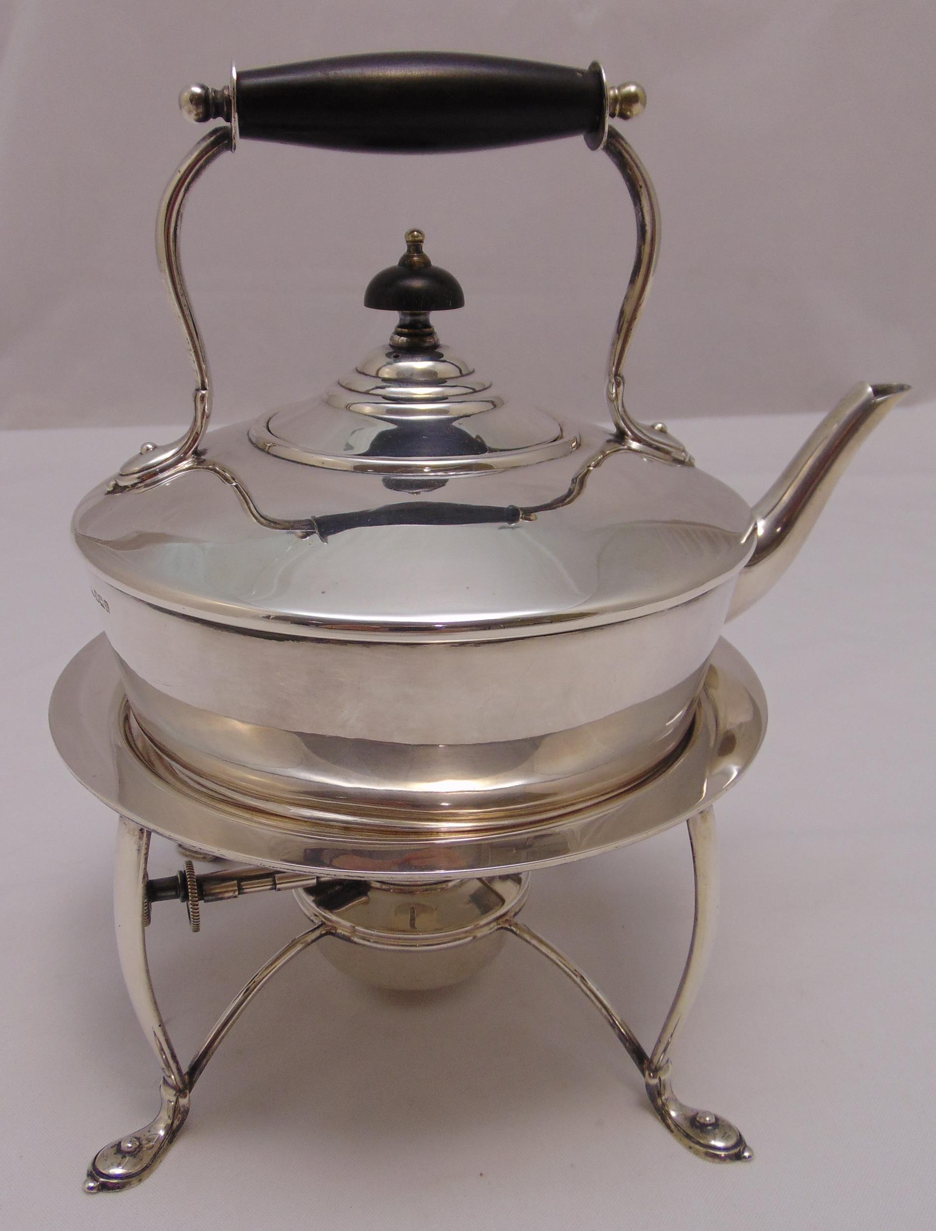 A Mappin and Webb hallmarked silver tea kettle on stand, of compressed cylindrical form with central