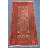 A Middle Eastern wool carpet red ground with repeating geometric patterns, 196 x 105.5cm