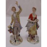 A pair of Dresden figurines of a lady and a man in 18th century attire on raised circular bases,