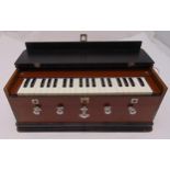 An Indian rectangular wooden cased Harmonium with five stops, pump action bellows and carrying