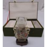 A reverse painted oriental glass scent bottle with hardwood stand in original case, 18.5cm (h)