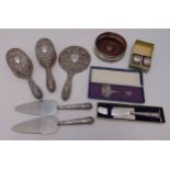 A quantity of hallmarked silver to include a three piece dressing table set, a pair of napkin rings,