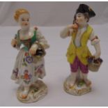 Two Meissen figurines of a boy and a girl carrying baskets of grapes on naturalistic bases, makes to