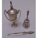A quantity of hallmarked silver to include a table bell, a letter opener and a trophy cup with