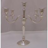 A hallmarked silver five light candelabrum tapering oval form with scrolling arms on raised oval