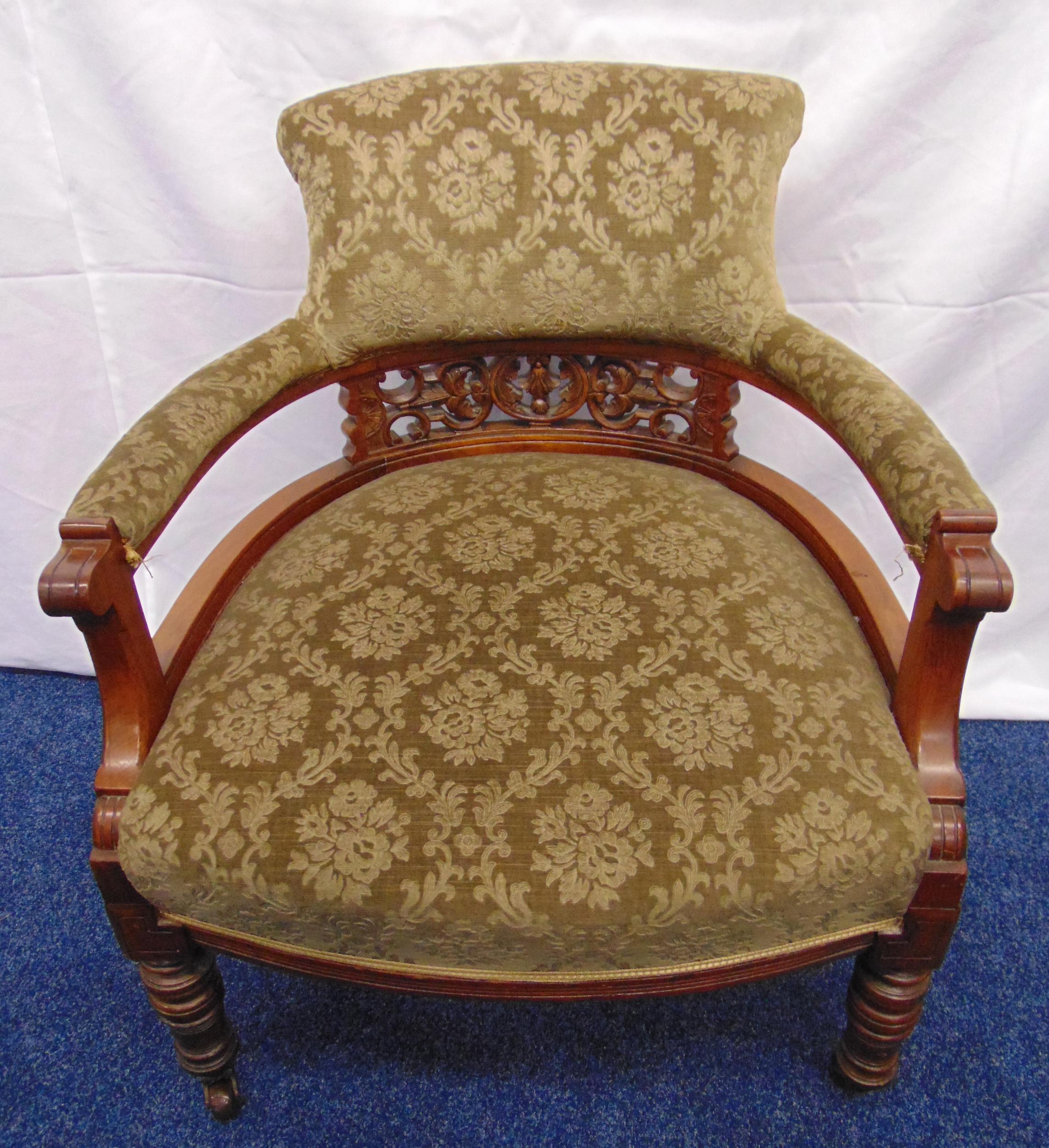 Victorian mahogany upholstered armchair on turned cylindrical legs with original castors