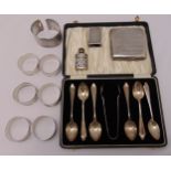 A quantity of hallmarked silver and white metal to include napkin rings, a cigarette case, a