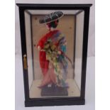 A cased porcelain oriental doll in traditional geisha costume 48.5 x 32 x 25.5cm