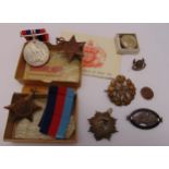 A quantity of military medals and badges to include war Service Australia, WWII 1939-1945 Star,