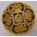 Meissen circular dish gilded with stylised flowers against a blue ground, 32cm (dia)