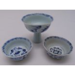 A pair of Ming style blue and white bowls and a blue and white stem cup, tallest 8.5cm (h)
