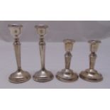 Two pairs of miniature hallmarked silver table candlesticks, one pair with beaded border