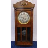 An oak cased two train movement wall regulator, silvered dial with Arabic numerals to include a