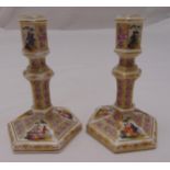 A pair of KPM Berlin early 19th century table candlesticks on hexagonal bases with Watteauesque