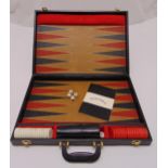 A cased backgammon set to include counters and dice