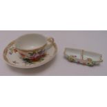 A Meissen 19th century cup and saucer decorated with flowers and gilded borders, marks to the