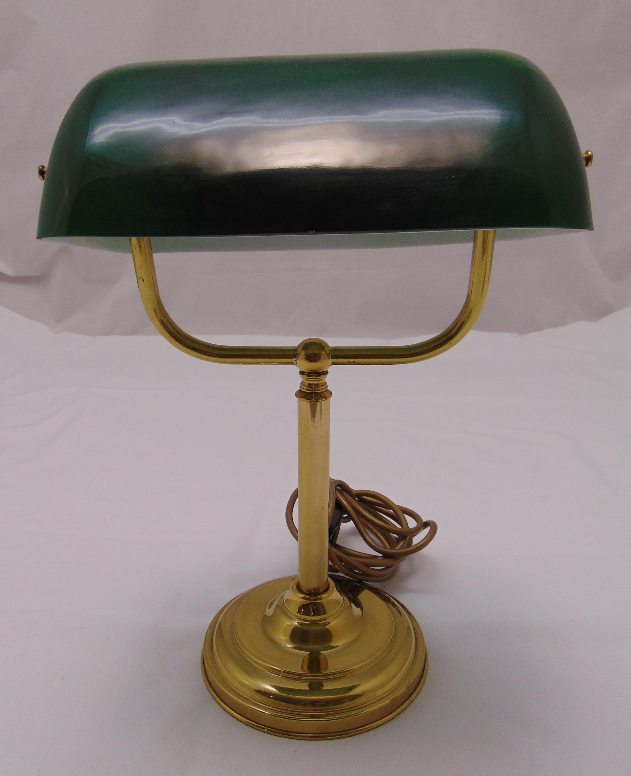 A brass desk lamp with green glass shade on raised circular base, 36.5cm (h)