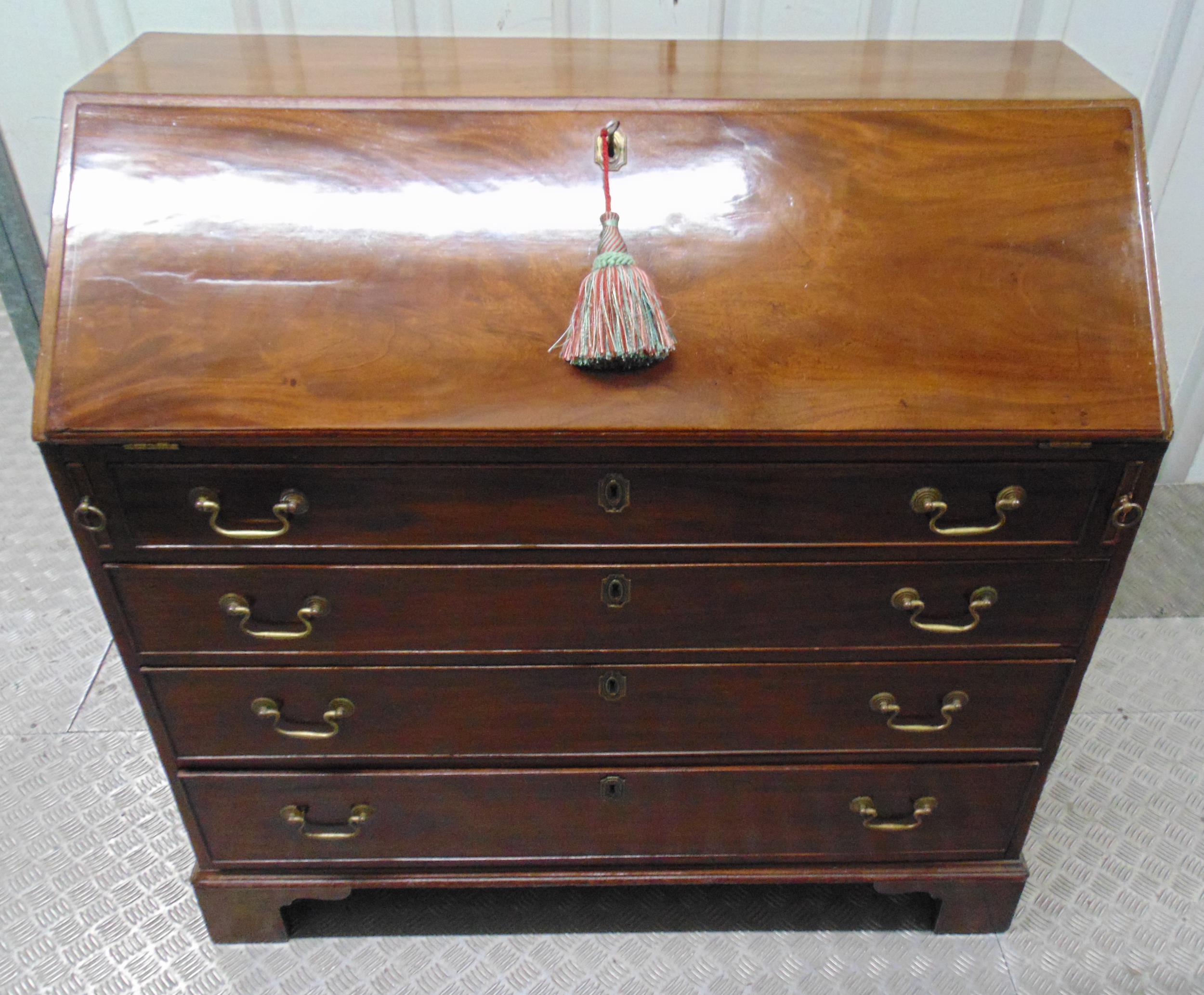 A 19th century rectangular mahogany bureau , the four drawers with brass swing handles on four