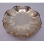 A hallmarked silver fruit dish with crimped and pierced border on raised circular base, Sheffield