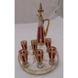 A Bohemian red and gold overlay liqueur set with six glasses, matching tray and decanter