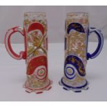 A pair of Bohemian overlaid glass steins with scroll handles on reticulated bases, 20cm (h) one A/F