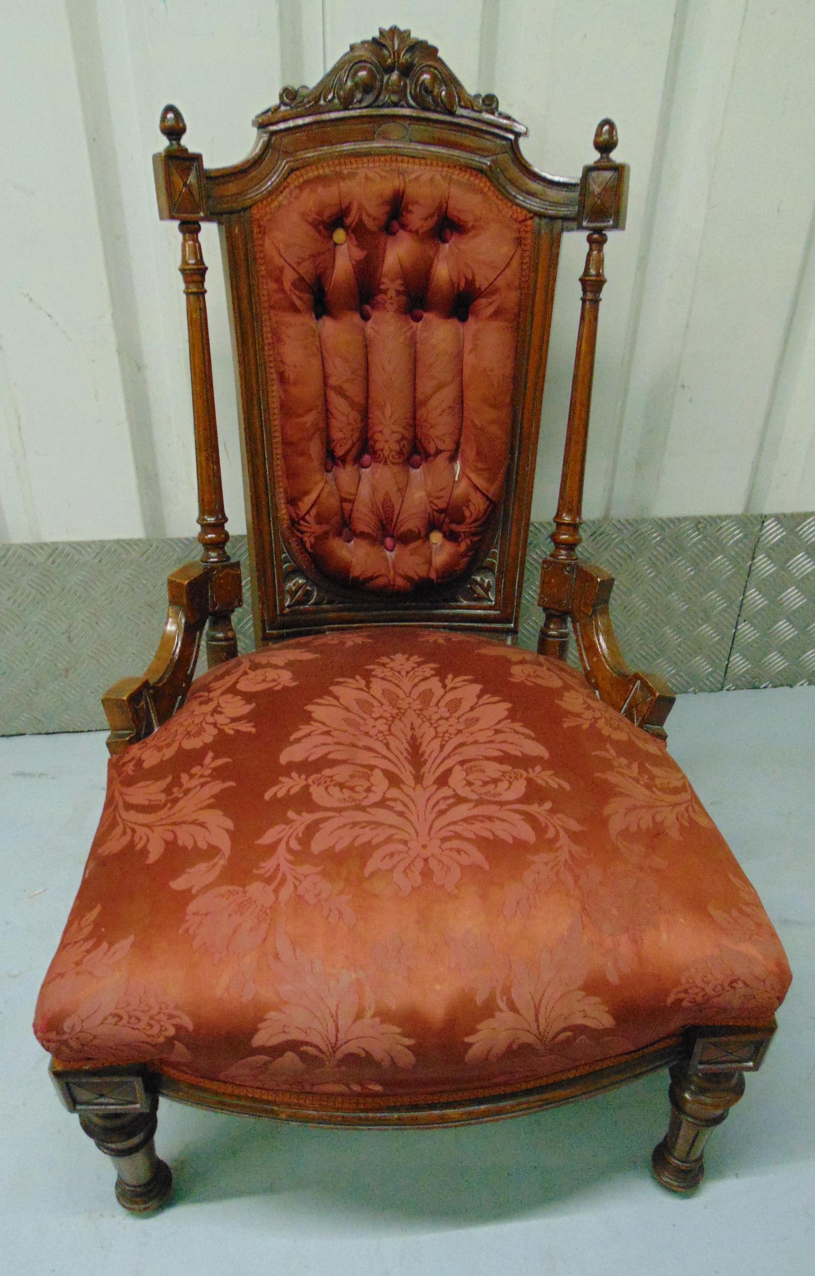 A Victorian mahogany upholstered nursing chair on four turned cylindrical legs