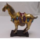 An oriental gilded metal and cloisonne‚ Tang horse on wooden rectangular plinth, 29 x 29cm
