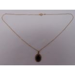 9ct gold and garnet pendant on a 9ct gold chain, approx total weight 3.9g