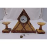 An Art Deco marble clock set of triangular form with white enamel dial and Arabic numerals,