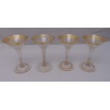 A set of four continental fluted ice cream glasses decorated with gilded flowers and leaves on