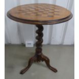A circular mahogany occasional table with inset chessboard top, barley twist stem on three