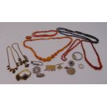 A quantity of costume jewellery to include a butterscotch amber graduated bead necklace, brooches, a
