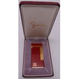 Givenchy 2000 red enamel and gilded cigarette lighter in original packaging