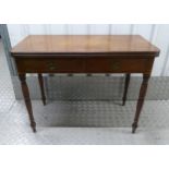 A Regency rectangular mahogany tea table, two drawers with brass handles on turned cylindrical legs,