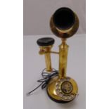 A gilded metal stick telephone of customary form on raised circular base, 32cm (h)