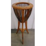 An Edwardian mahogany plant stand of conical form, slatted sides on three outswept legs, 90 x 35cm