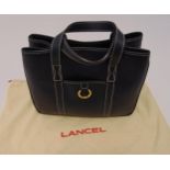 Lancel leather ladies handbag with brass clasp and protective cloth cover