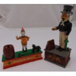 Two cast iron money boxes in the form of a. Uncle Sam 28.5x 12 x 9.5cm b. Trick Dog 19 x 25x 7cm