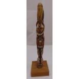 A South American hand painted totem pole, the stylised figures on square plinth, 77cm (h)