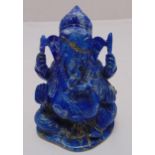 A carved lapis lazuli style figurine of Ganesha, on shaped oval base, 12cm (h)
