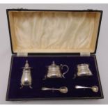 A cased set of hallmarked silver condiments to include a mustard pot, pepperette, salt and two