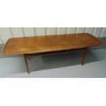 A mid 20th century rectangular teak coffee table on four tapering cylindrical legs, 47 x 150 x 52.